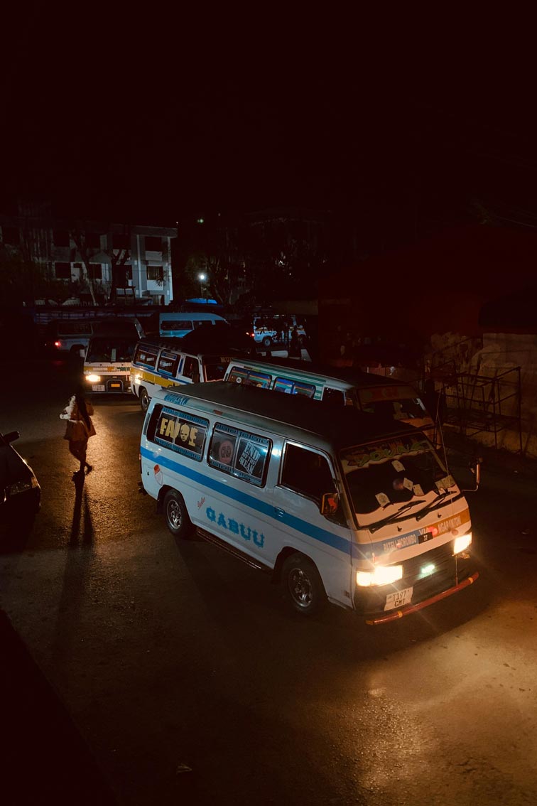 White and blue Toyota Hiace van on road during night time